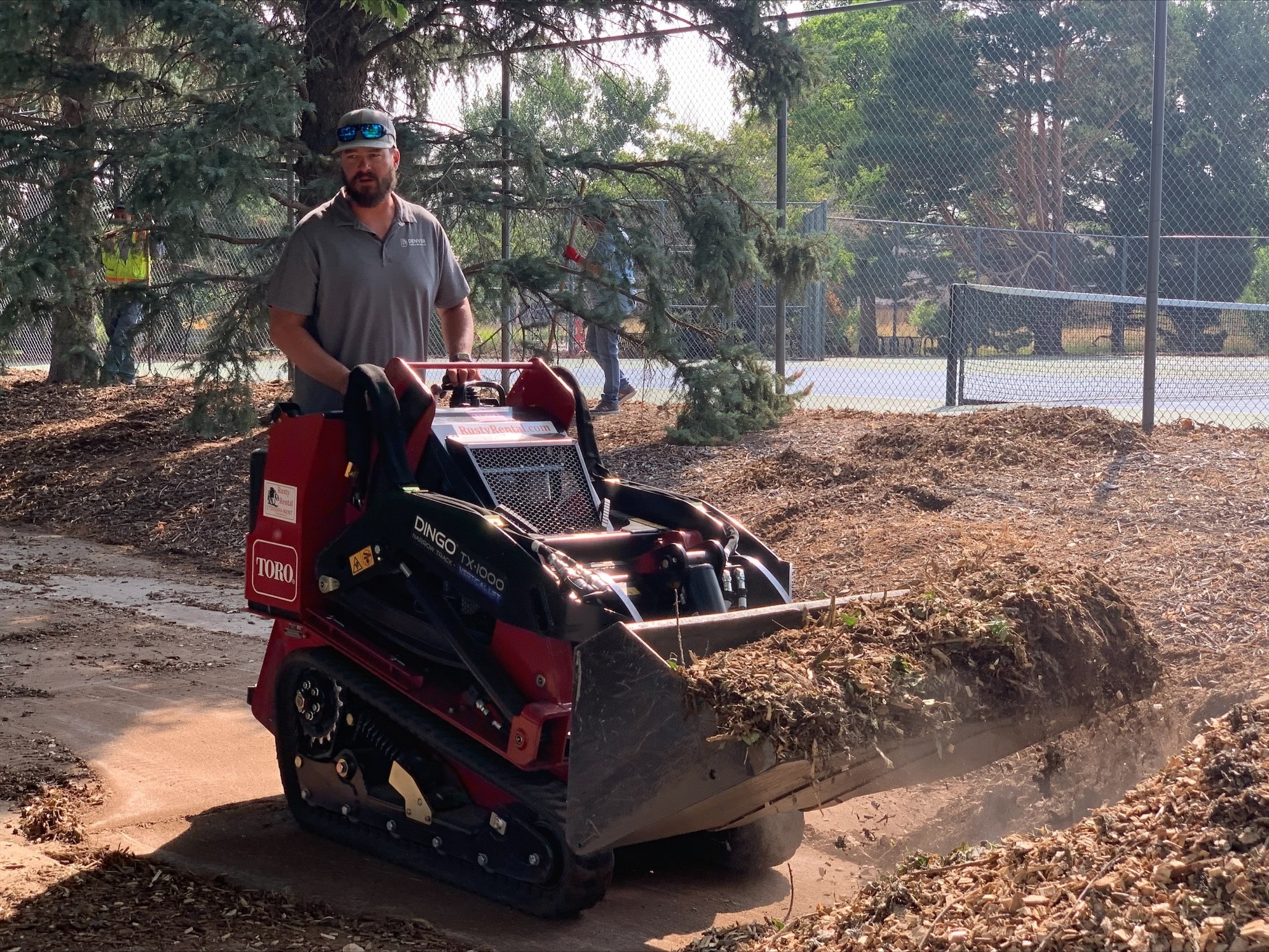 1654816056617 A Toro Dingo Tx 1000 Helps Clear Mulch During The Daylong Community Impact