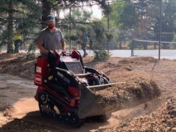 A Toro Dingo TX 1000 helps clear mulch during the daylong Community Impact Project