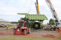 The big moment, as a Link-Belt HTC86100 and Grove RT880E lower Terex Titan&rsquo;s restored dump bed into place. The Taylor 26-ton forklift assisted one crane in rolling the bed into lifting position after its halves were welded together.