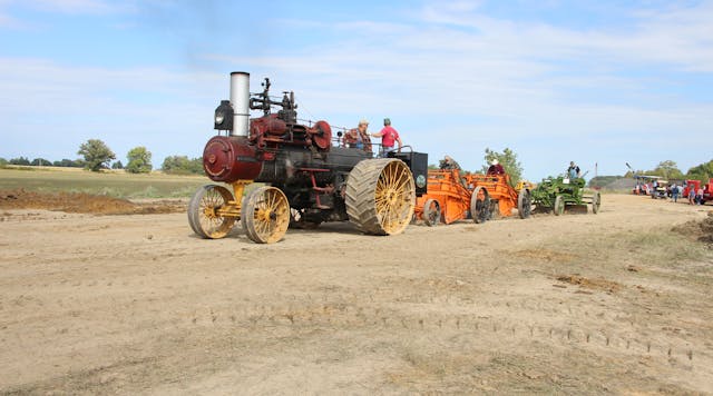A 1918 Russell &amp; Co. 30/90 traction engine pulls two 1920s Baker Maney D wheeled scrapers and a 1929 Galion Leaning Wheel E-Z Lift No. 10 pull grader.