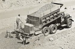 A Jaeger SPS-W series base paver lays material on part of the Pennsylvania Turnpike. The “W” indicates wheel mounting instead of crawlers. A Jaeger SPS-W series base paver lays material on part of the Pennsylvania Turnpike. The “W” indicates wheel mounting instead of crawlers.