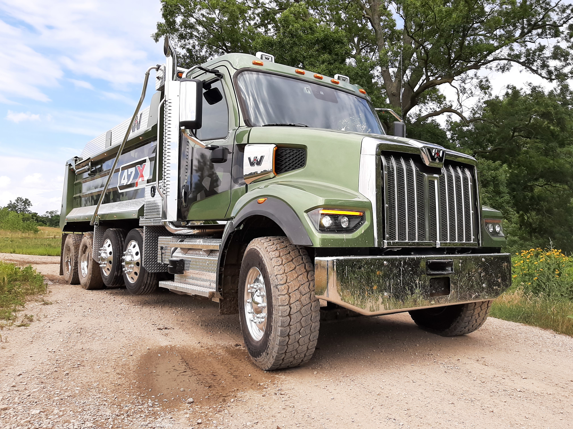 Money-green paint and geometric-decor graphics look good on the handsome 47X as it pauses after running one of two off-road courses at proving grounds outside of Detroit. The tandem and two lift axles make it a &ldquo;quad&rdquo; used in several states. Lenses of the cool-burning LED headlamps have heating grids to melt snow and ice. New &ldquo;Daimler cab&rdquo; is steel-framed, aluminum skinned, and wide enough for a crew of three. In the dump bed were 15 tons of gravel, but the truck would scale well under its rated GVW of 86,040 pounds.