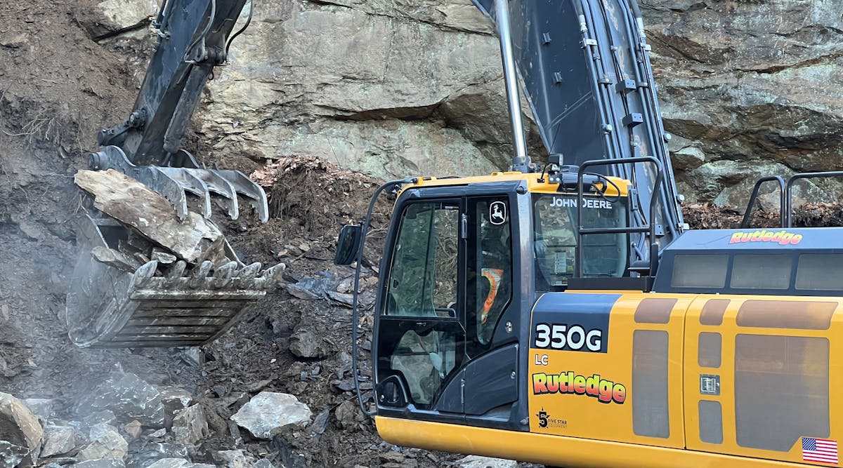 A Rutledge excavator grabs rock on a mountainside in Pennsylvania for use in a stream bed.