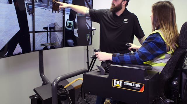 A Simformotion trainer explains how to operate an excavator effectively to a student training on a Cat Simulators system.