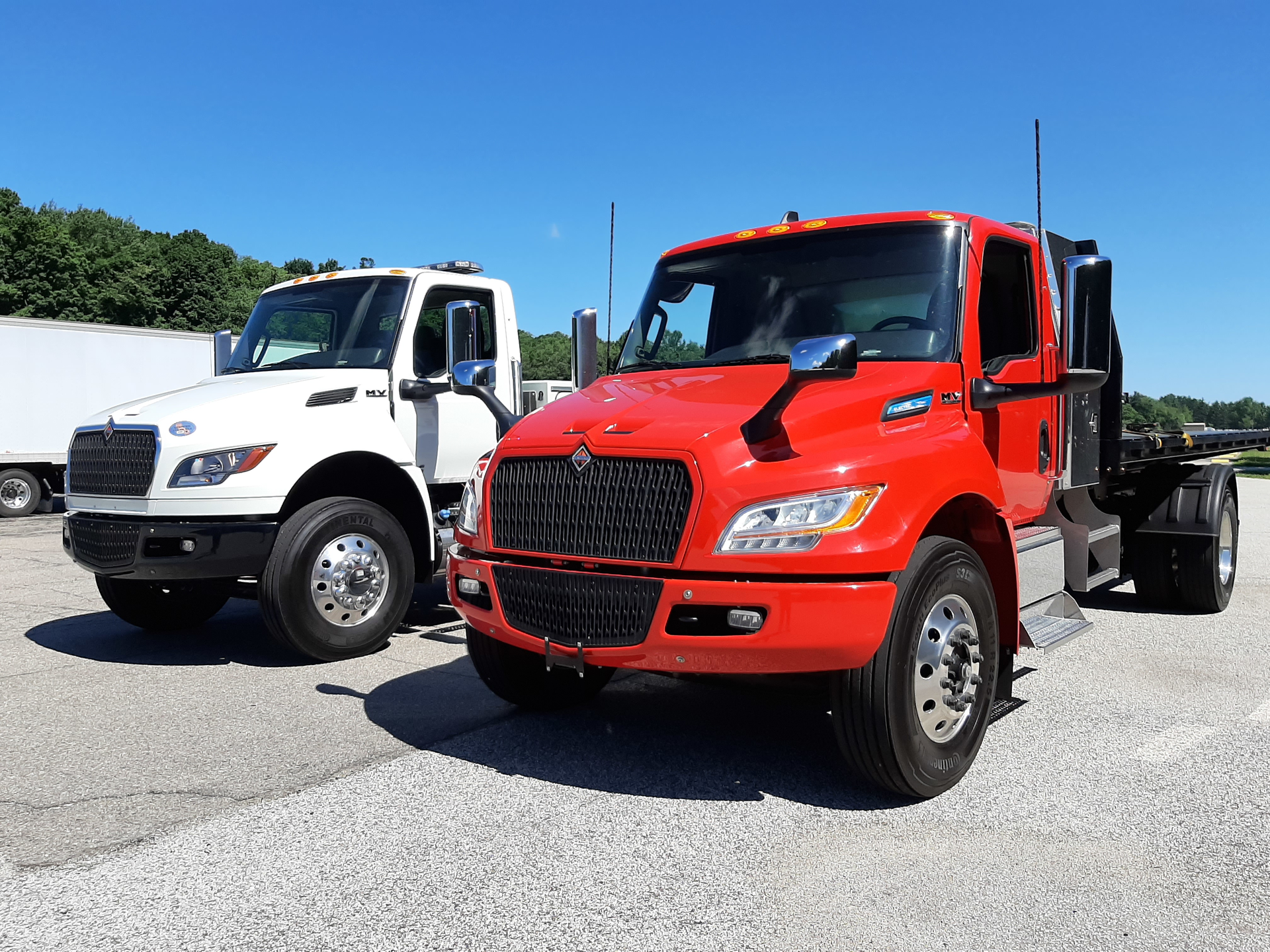 Viper red Class 7 eMV poses with a Cummins diesel-powered MV, International&rsquo;s popular Medium Vocational model, at the Navistar Proving Grounds in Indiana. Cabs, frames, and suspensions are shared between the two otherwise dissimilar vehicles, though eMV&rsquo;s gauge cluster is digital (inset). The drive system is taken from Navistar&rsquo;s proven IC electric school buses. The eMV&rsquo;s range is 135 miles, depending on operations, and the goal for future models is 200 miles. A Class 6 version for non-CDL drivers is also offered.