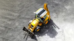 A solar panel on a backhoe loader.