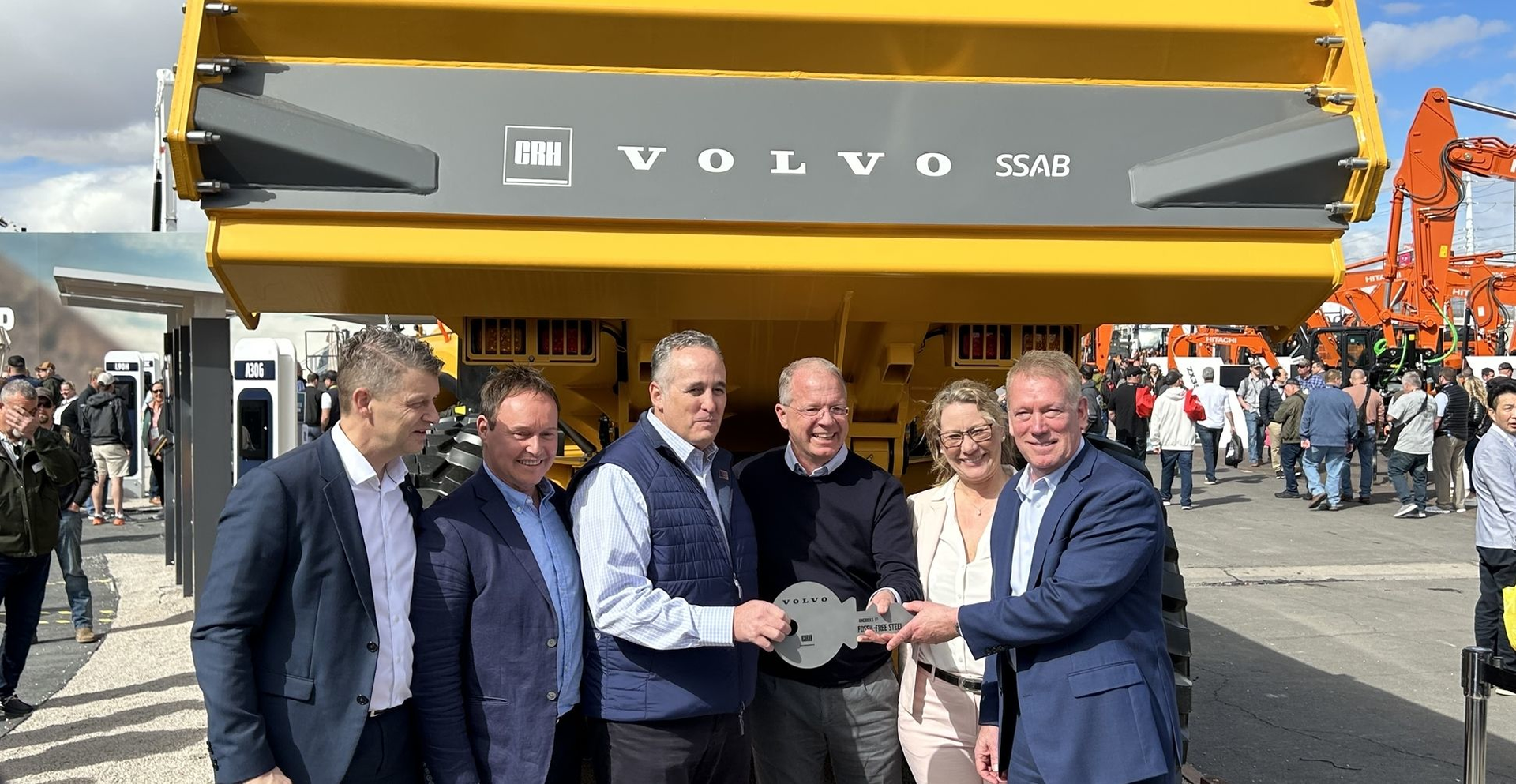 Volvo executives pose at Conexpo with an ADT made from fossil-free steel.