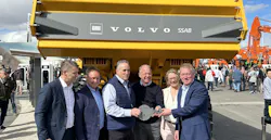 Volvo executives pose at Conexpo with an ADT made from fossil-free steel.