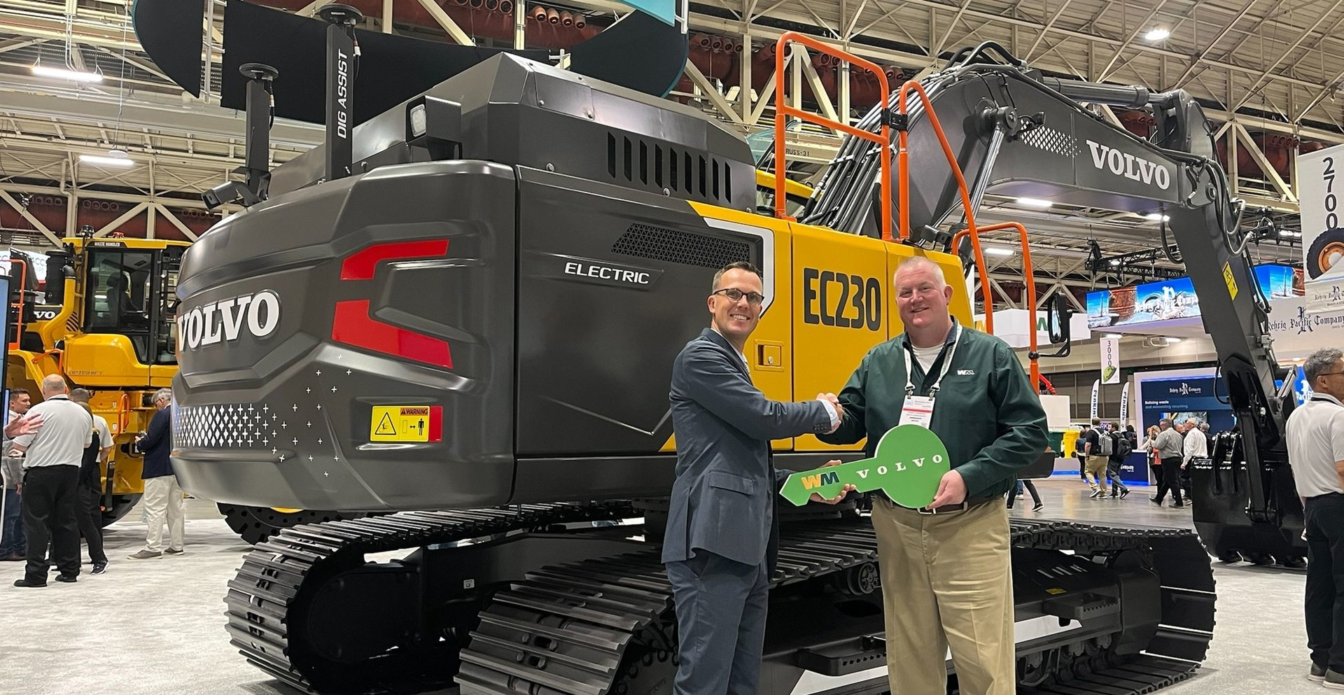 Martin Mattsson, key accounts director &mdash; waste and recycling at Volvo CE (left), hands over the EC230 Electric keys to Harold Romberg, director of heavy equipment for WM, at Waste Expo.