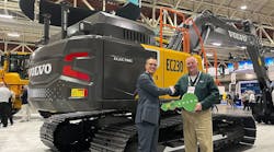Martin Mattsson, key accounts director &mdash; waste and recycling at Volvo CE (left), hands over the EC230 Electric keys to Harold Romberg, director of heavy equipment for WM, at Waste Expo.