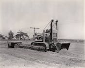 On a road job near Galva, Illinois, in September, 1938, a Cat D4 with a High Loader is spreading fill, plus towing a disc and a pneumatic roller. It also ditched, placed pipe, and cleared brush. The machine handled excavation as well, including overburden, gravel, and earth and rock cuts.
