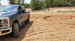 Trail Turn Assist feature applies inside rear-wheel brake to drag the truck through turns and drastically reduce a turning circle, as shown by ruts in the sand near the cone. Without Trail Turn Assist, Super Duty 4x4 took much more room to turn.