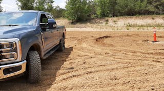 Trail Turn Assist feature applies inside rear-wheel brake to drag the truck through turns and drastically reduce a turning circle, as shown by ruts in the sand near the cone. Without Trail Turn Assist, Super Duty 4x4 took much more room to turn.