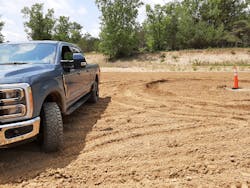 Trail Turn Assist feature applies inside rear-wheel brake to drag the truck through turns and drastically reduce a turning circle, as shown by ruts in the sand near the cone. Without Trail Turn Assist, Super Duty 4x4 took much more room to turn. Trail Turn Assist feature applies inside rear-wheel brake to drag the truck through turns and drastically reduce a turning circle, as shown by ruts in the sand near the cone. Without Trail Turn Assist, Super Duty 4x4 took much more room to turn.