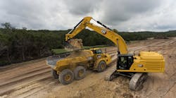 Cat 352 excavator loading an articulated haul truck.