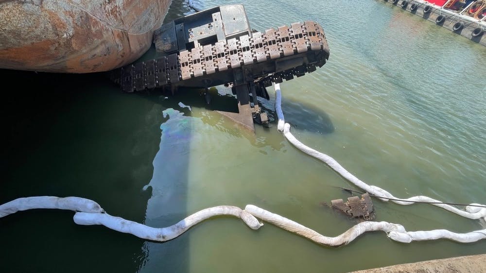 A crane sits in the water at Wepfer Marine Drydock near Memphis, Tennessee. The cause of the incident is under investigation. (U.S. Coast Guard photo by Chief Petty Officer Will Parris)