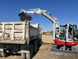The TB257FR and its one-piece boom had plenty of clearance to fill this conventional dumper. The TB257FR and its one-piece boom had plenty of clearance to fill this conventional dumper.