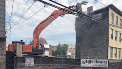 This excavator has plenty of room at the moment. Distance from the wall, distance from the wires. But what if it didn’t? That’s where remote-control operation can enter the equation—from outside the fence line. This excavator has plenty of room at the moment. Distance from the wall, distance from the wires. But what if it didn’t? That’s where remote-control operation can enter the equation—from outside the fence line.