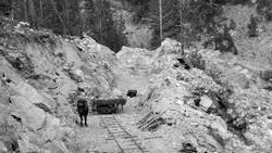 By August, more modernization has taken hold, however slightly, as the dump cart is pulled by a horse. The rocky material, blasted after John Henrying the blastholes by hand, was typical for the job. Note too the section of track leaning against the cut face. A second cart is perched on the rocks to the right of the face.