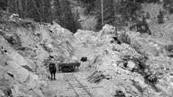 By August, more modernization has taken hold, however slightly, as the dump cart is pulled by a horse. The rocky material, blasted after John Henrying the blastholes by hand, was typical for the job. Note too the section of track leaning against the cut face. A second cart is perched on the rocks to the right of the face. By August, more modernization has taken hold, however slightly, as the dump cart is pulled by a horse. The rocky material, blasted after John Henrying the blastholes by hand, was typical for the job. Note too the section of track leaning against the cut face. A second cart is perched on the rocks to the right of the face.