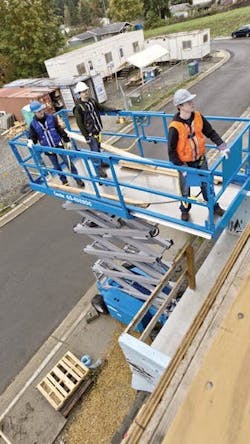 A larger electric-drive scissor lift in action. Some electric scissors allow work more than 40 feet in the air.