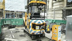 JCB&apos;s Fast Charger powers up a mini excavator on an urban job site. This portable charging solution can also be used when there is no power source nearby.