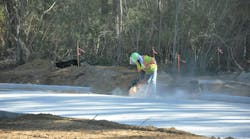 A worker using a concrete saw. A worker using a concrete saw.