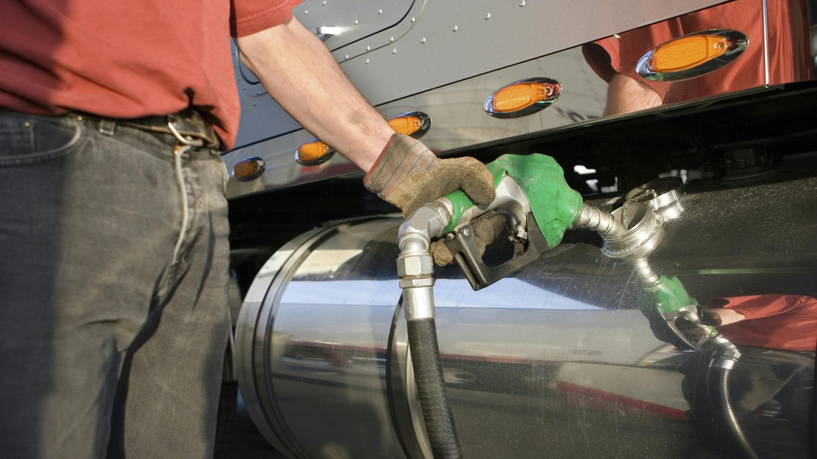 Man Pumping Renewable Gas into Semi