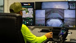 Operator Max Bogacz remotely operating articulated dump trucks 40 miles out from the job site. Operator Max Bogacz remotely operating articulated dump trucks 40 miles out from the job site.