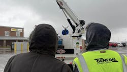Participants at the demo day observing the operation of a crane.