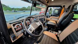 Premium interior trim’s two-tone fabrics and panels are tastefully subdued and attractive. Two flat panels house color gauges and info screens, and well positioned rocker switches. The flat-bottomed steering wheel adds thigh room. Similar interiors are used in cabs of other heavy Mack models, including Pinnacle highway tractors. Premium interior trim’s two-tone fabrics and panels are tastefully subdued and attractive. Two flat panels house color gauges and info screens, and well positioned rocker switches. The flat-bottomed steering wheel adds thigh room. Similar interiors are used in cabs of other heavy Mack models, including Pinnacle highway tractors.