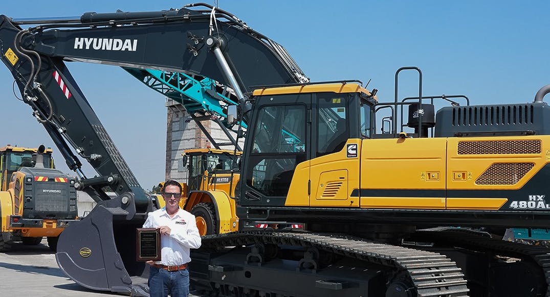 Powerscreen of California President Gary McConn displays the company&rsquo;s official HD Hyundai Construction Equipment dealership plaque.
