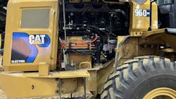 A prototype battery-electric wheel loader from Caterpillar. Note one of the batteries visible at the bottom of the open panel. A prototype battery-electric wheel loader from Caterpillar. Note one of the batteries visible at the bottom of the open panel.