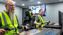 Three operator trainees work together in Cat Simulators Collaborative Worksite Training, cleaning up a spoil pile with a dozer and loading the material into an articulated truck with an excavator. Three operator trainees work together in Cat Simulators Collaborative Worksite Training, cleaning up a spoil pile with a dozer and loading the material into an articulated truck with an excavator.