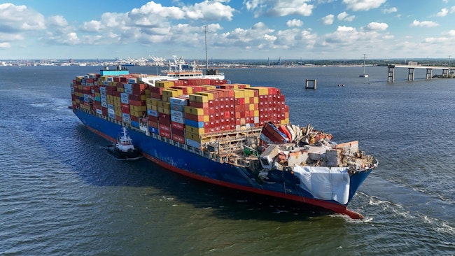 The container ship Dali is escorted through the Francis Scott Key Bridge collapse site on its way to Norfolk Monday morning 90 days after the ship hit a support pier of the bridge causing a catastrophic collapse.