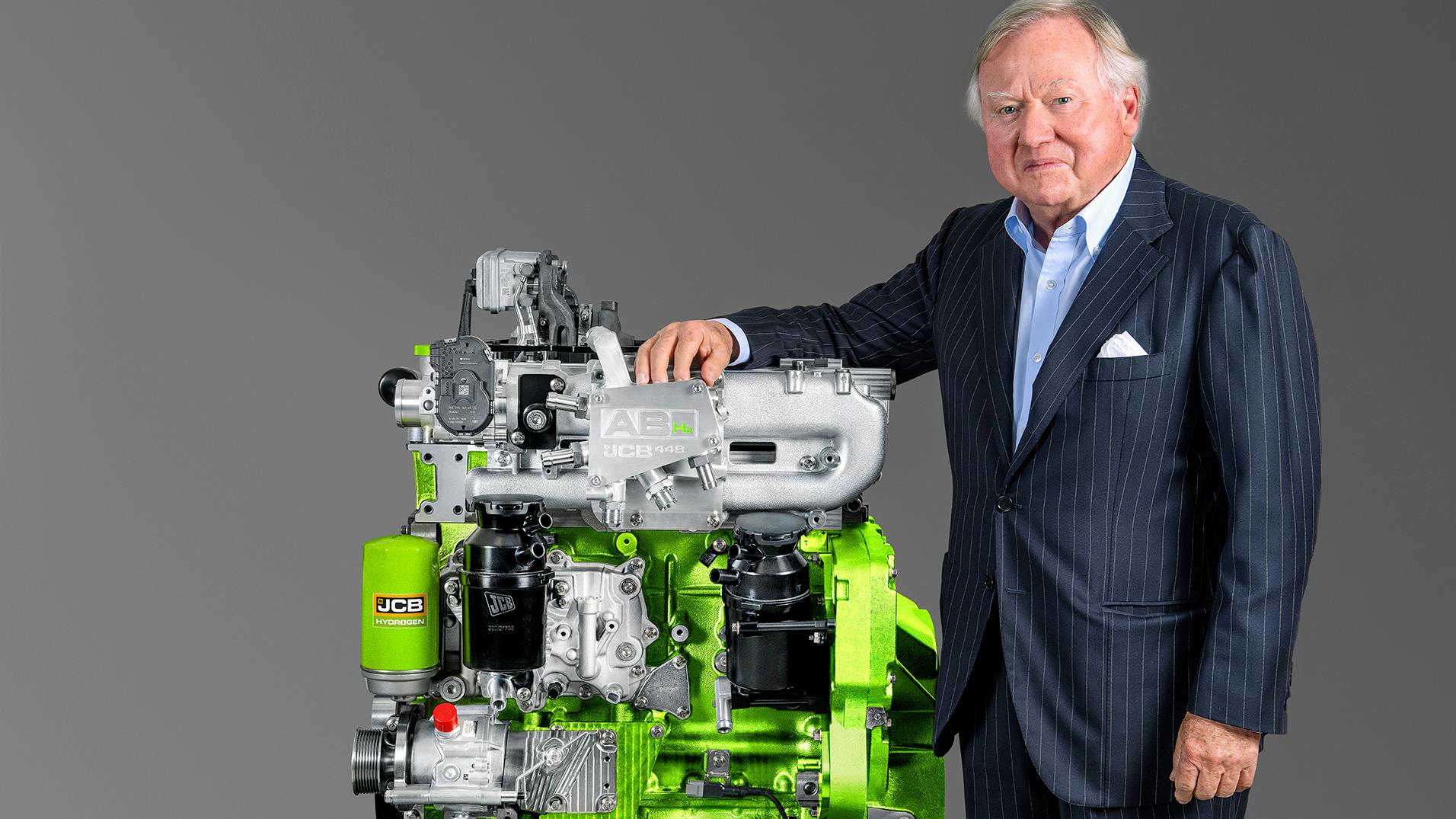 JCB chairman Bamford pictured with JCB&rsquo;s hydrogen combustion engine.