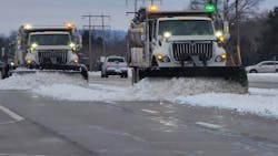 A trio of single-rear-axle plow trucks sporting green and amber strobes cleans a stretch of Ohio highway after a storm has passed. Green lights are used only on snowplows, differentiating them from other road-maintenance equipment with amber-only lights. A trio of single-rear-axle plow trucks sporting green and amber strobes cleans a stretch of Ohio highway after a storm has passed. Green lights are used only on snowplows, differentiating them from other road-maintenance equipment with amber-only lights.