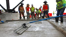 Workers finish C-Crete mixed on-site by Bauman Redi-Mix. Workers finish C-Crete mixed on-site by Bauman Redi-Mix.