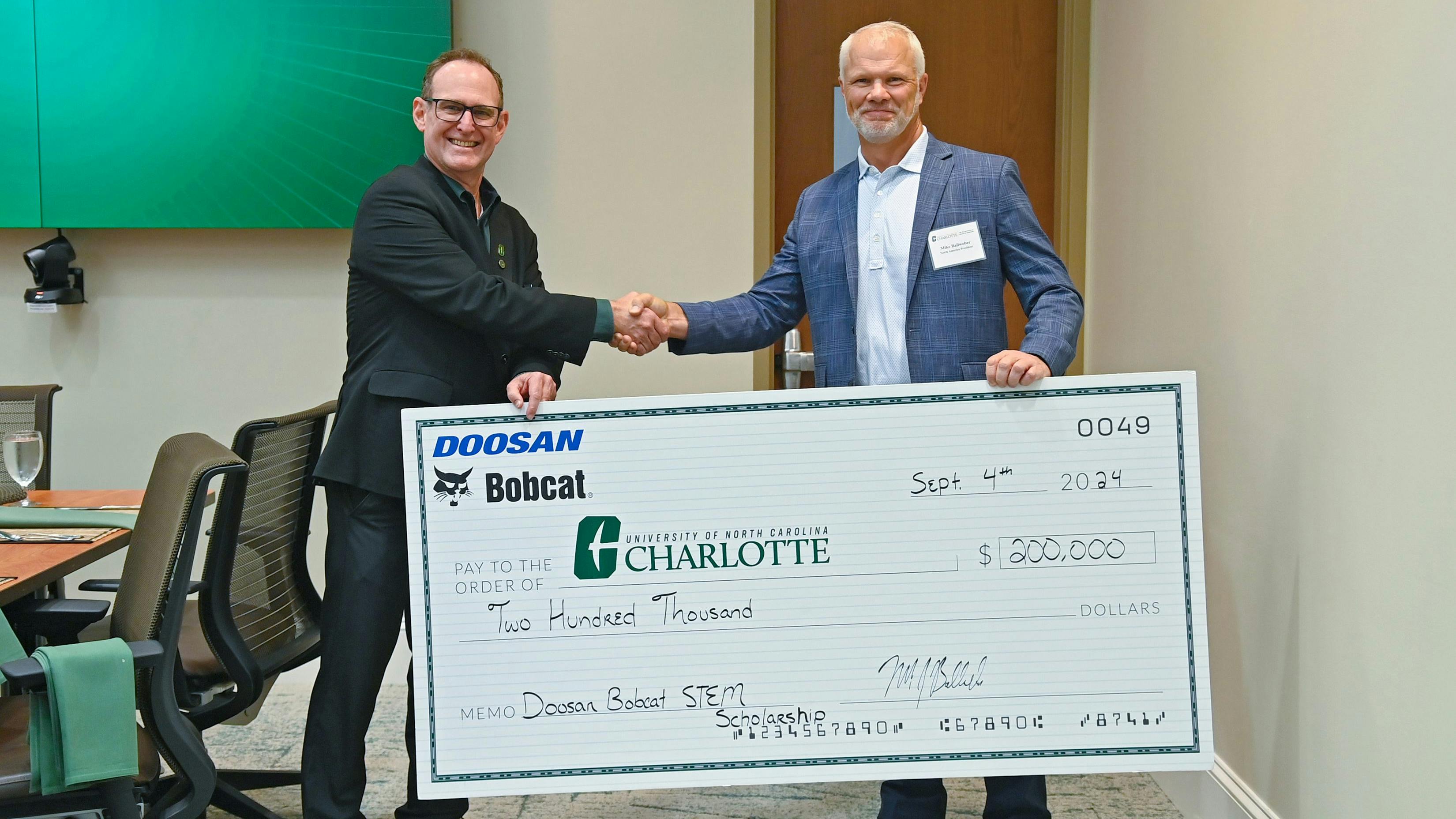 Dr. Robert Keynton, (left) dean of William States Lee College of Engineering at UNC Charlotte, and Mike Ballweber, president of Doosan Bobcat North America