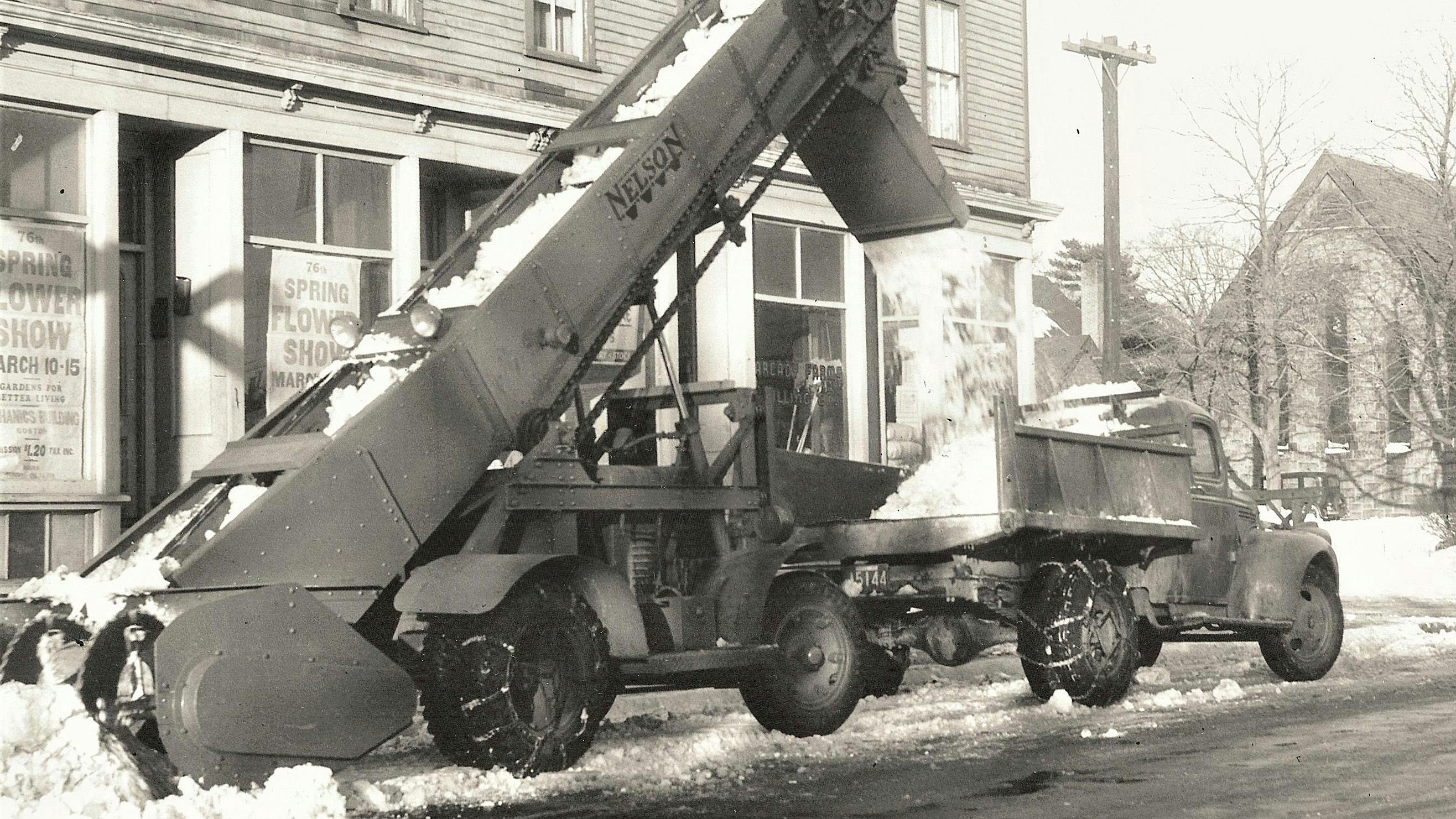 A Model R-11 loading snow in Boston, Massachusetts, in the late 1940s. Note the hydraulic boom raise cylinder. The window posters advertise the Spring Flower Show, March 10-15, admission only $1.20.