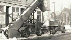 A Model R-11 loading snow in Boston, Massachusetts, in the late 1940s. Note the hydraulic boom raise cylinder. The window posters advertise the Spring Flower Show, March 10-15, admission only $1.20. A Model R-11 loading snow in Boston, Massachusetts, in the late 1940s. Note the hydraulic boom raise cylinder. The window posters advertise the Spring Flower Show, March 10-15, admission only $1.20.