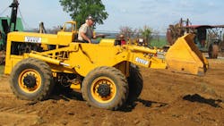 Nelson Model 150 wheel loader, built in 1960. Note the loader arms, curving up from below the operator’s station to aid visibility and prevent injury to the operator. Nelson Model 150 wheel loader, built in 1960. Note the loader arms, curving up from below the operator’s station to aid visibility and prevent injury to the operator.