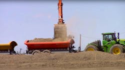 Global CM used two excavators to load dirt into the side dump trailer train. Global CM used two excavators to load dirt into the side dump trailer train.