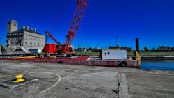 A crane on a barge works on the Soo Locks in Sault Ste Marie, Michigan. A crane on a barge works on the Soo Locks in Sault Ste Marie, Michigan.