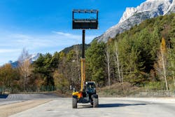 Liebherr T48-8s Telehandler with grapple bucket attachment reaching high into the sky Liebherr T48-8s Telehandler with grapple bucket attachment reaching high into the sky