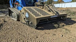 Blue Diamond rock rake attachment on a compact track loader in the dirt Blue Diamond rock rake attachment on a compact track loader in the dirt
