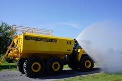 Philippi-Hagenbuch watertank spraying water on green grass Philippi-Hagenbuch watertank spraying water on green grass