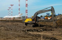 Volvo Construction Equipment EC210 crawler excavator working near an airport Volvo Construction Equipment EC210 crawler excavator working near an airport