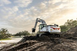 Bobcat e220 large excavator digging in the dirt Bobcat e220 large excavator digging in the dirt