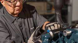 Kubota Engine America diesel engine mechanic doing maintenance Kubota Engine America diesel engine mechanic doing maintenance